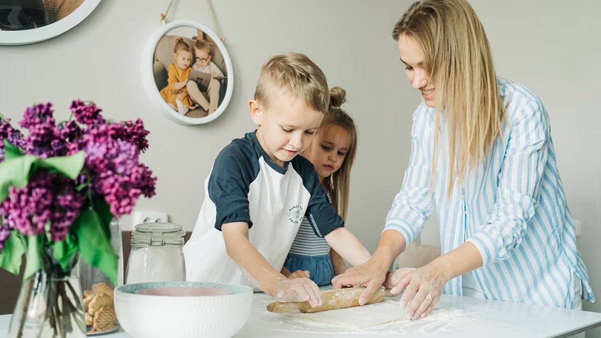 Mother and children enjoying a fun and messy baking session together at home.
